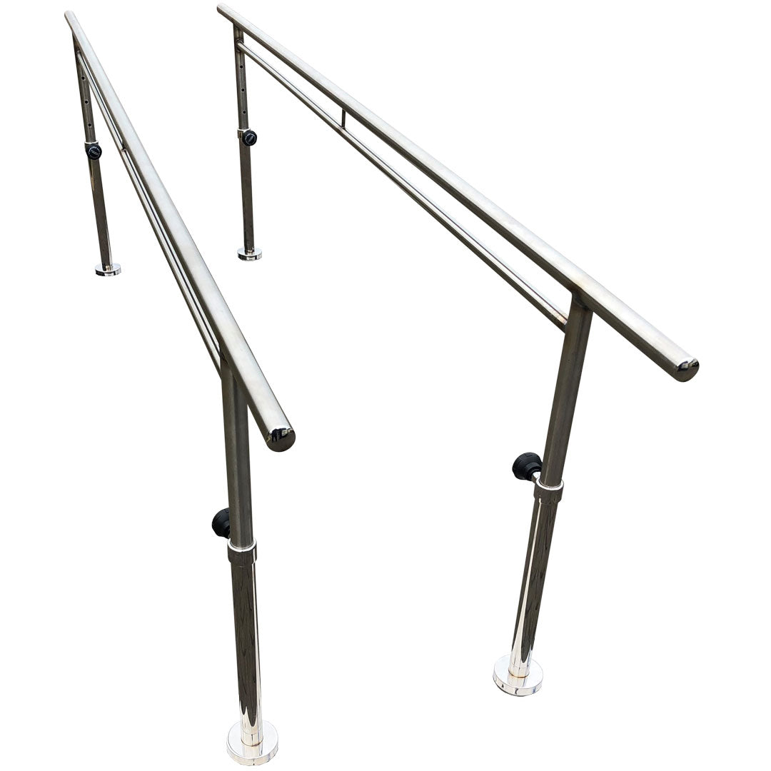 A pair of stainless steel parallel walking bars with adjustable height mechanisms and a bolt down fixed base, isolated on a white background.