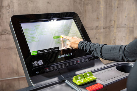 A person interacting the displayed screen in a treadmill.