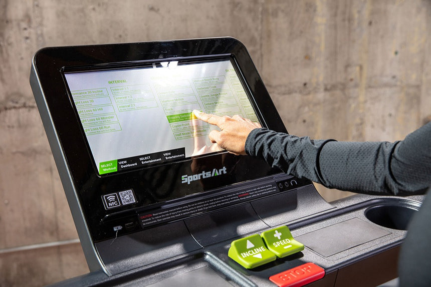 A person interacting the displayed screen in a treadmill.