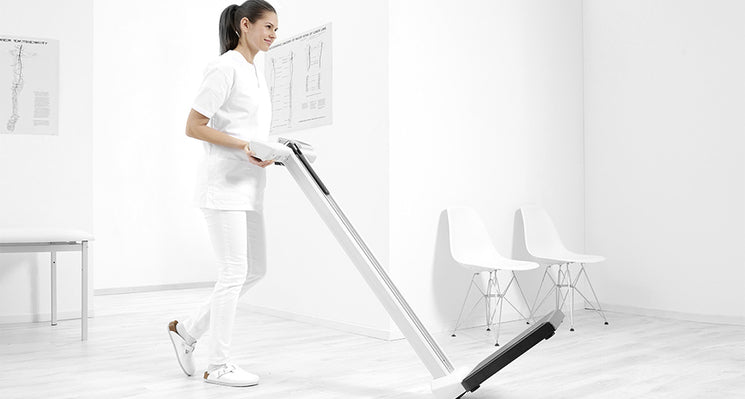 A health professional adjusting an exercise device.